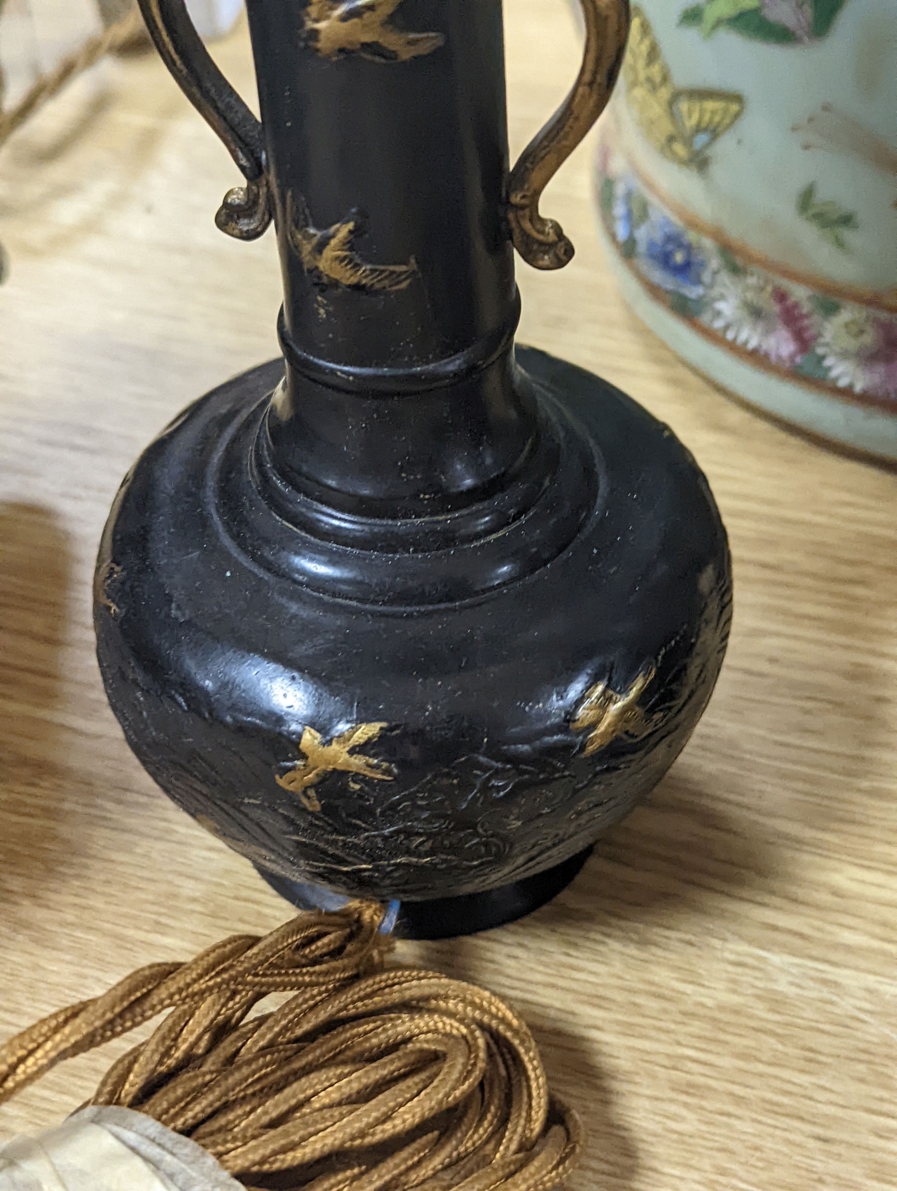 A decorative scroll brass inkstand, together with a pair of lamps, 29cm tall, (3)